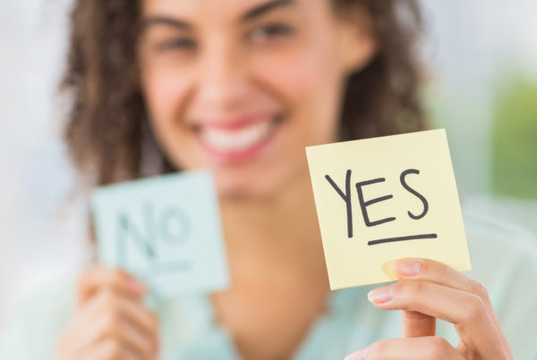 woman holding yes sticky note